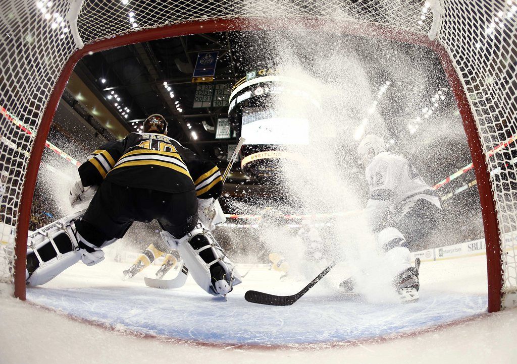 In this photo taken with a fisheye lens, Boston Bruins goalie Tuukka Rask protects the net as Tampa Bay Lightning's Dana Tyrell stops in his crease during the third period of Boston's 2-0 win in an NHL hockey game in Boston, Thursday, April 25, 2013. (AP Photo/Winslow Townson)