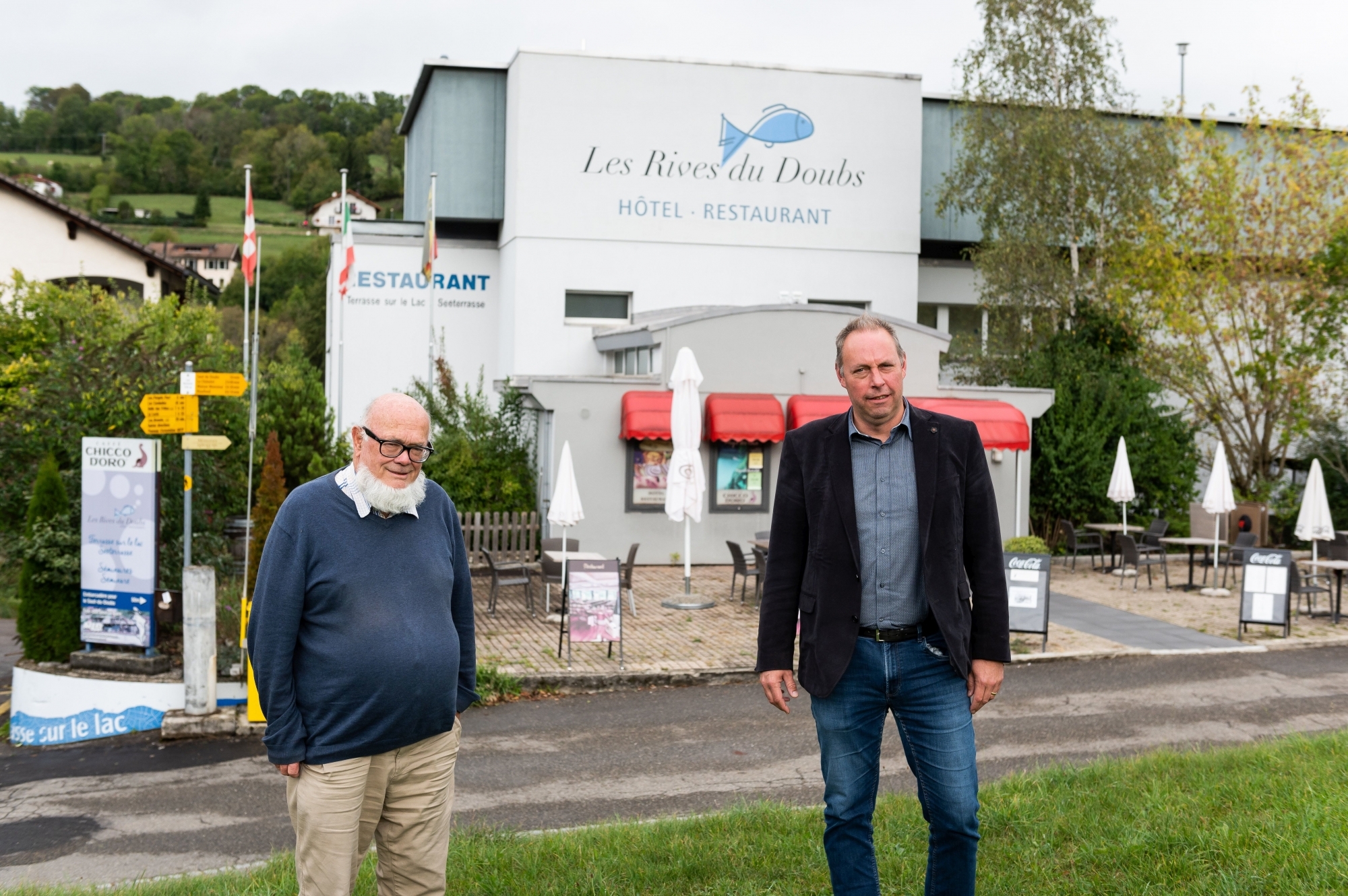 Claude Borel avec derrière lui Les Rives du Doubs dont il fait don aux Brenets comme cadeau de noces avec Le Locle. À ses côtés, José Decrauzat, président de la commune des Brenets.