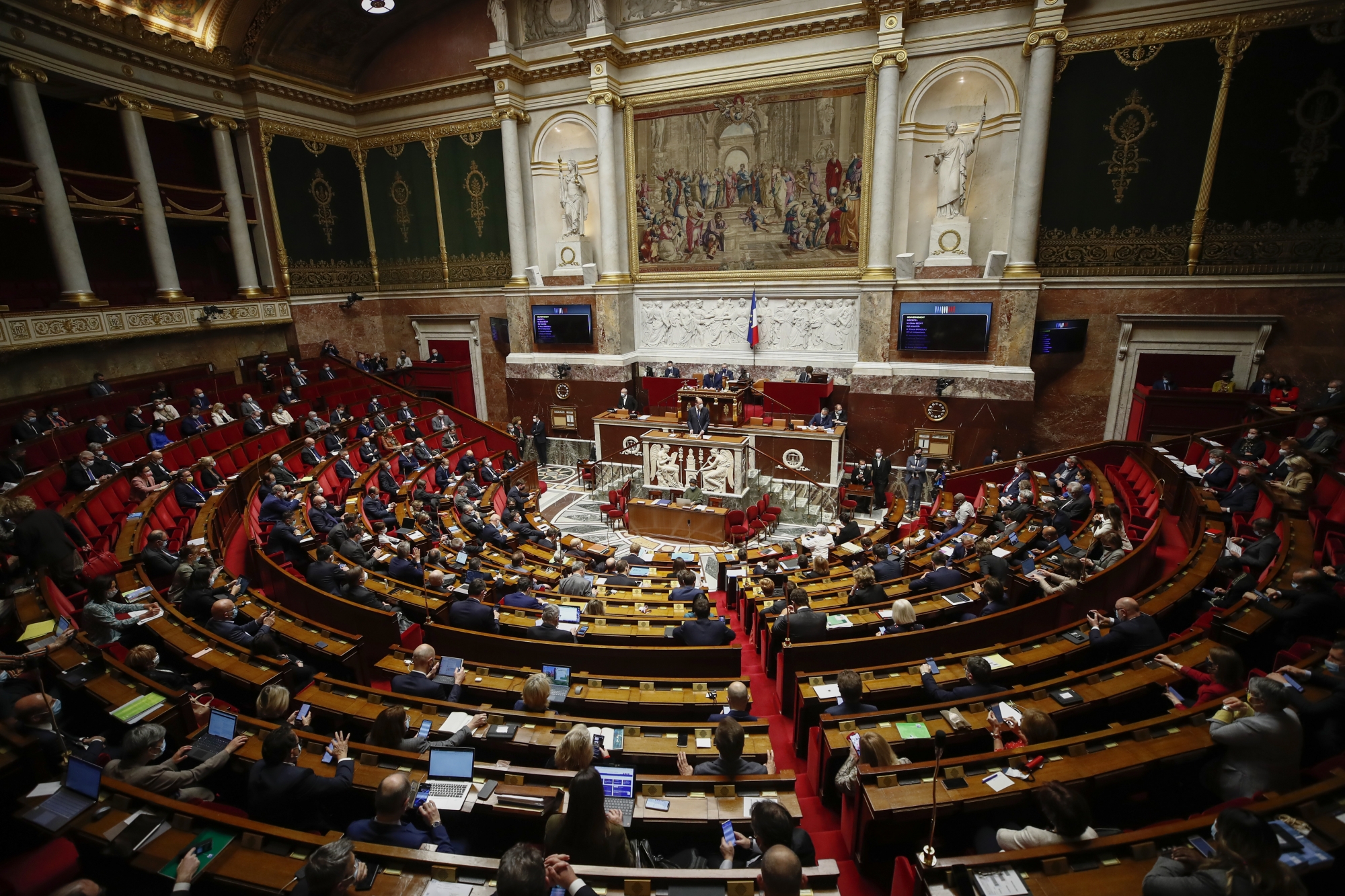 General view of the French parliament during a debate on the new Covid-19 measures at the National Assembly in Paris, Thursday, April 1, 2021. French President Emmanuel Macron on Wednesday announced a three week nationwide school closure and a month-long domestic travel ban as the rapid lisped of the virus ramps up pressure on hospitals. (AP Photo/Michel Euler).Jean Castex