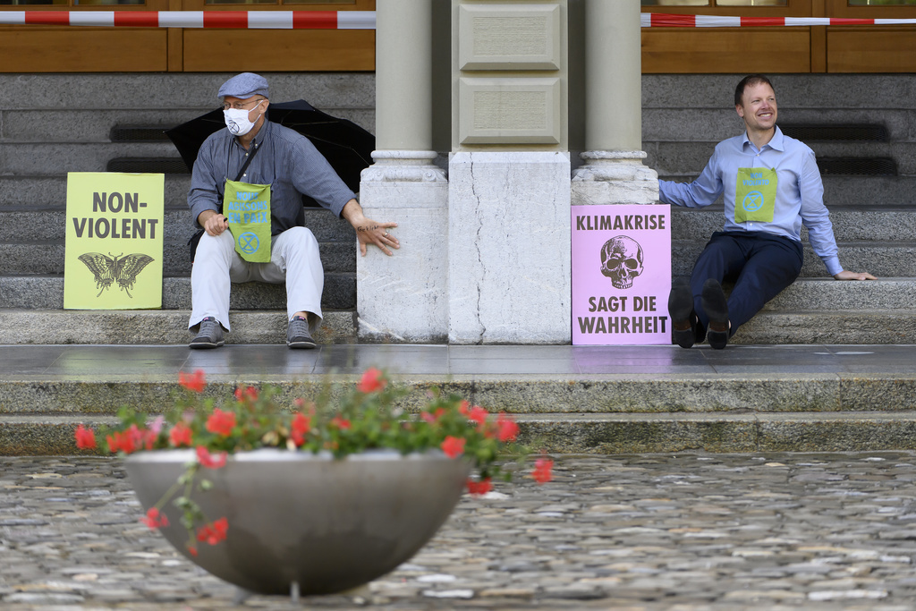 Les activistes ont collé leur main au Palais fédéral pour montrer leur détermination.