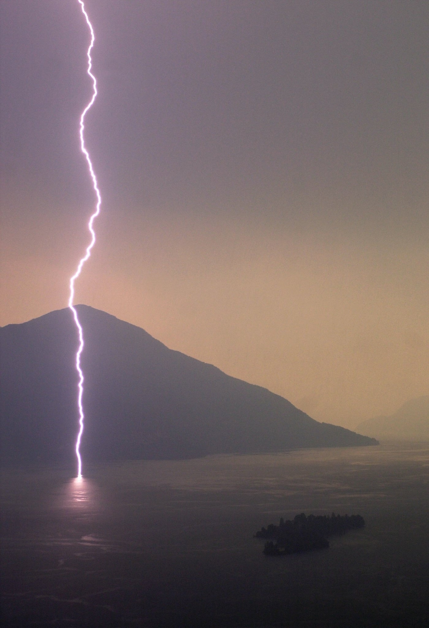 On the opening night of the 54th International Film Festival of Locarno, lightning illuminates the sky over the Lago Maggiore lake, seen from Roncon near Locarno, in the southern part of Switzerland, Thursday, August 2, 2001. (KEYSTONE/Martial Trezzini) === ELECTRONIC IMAGE ===