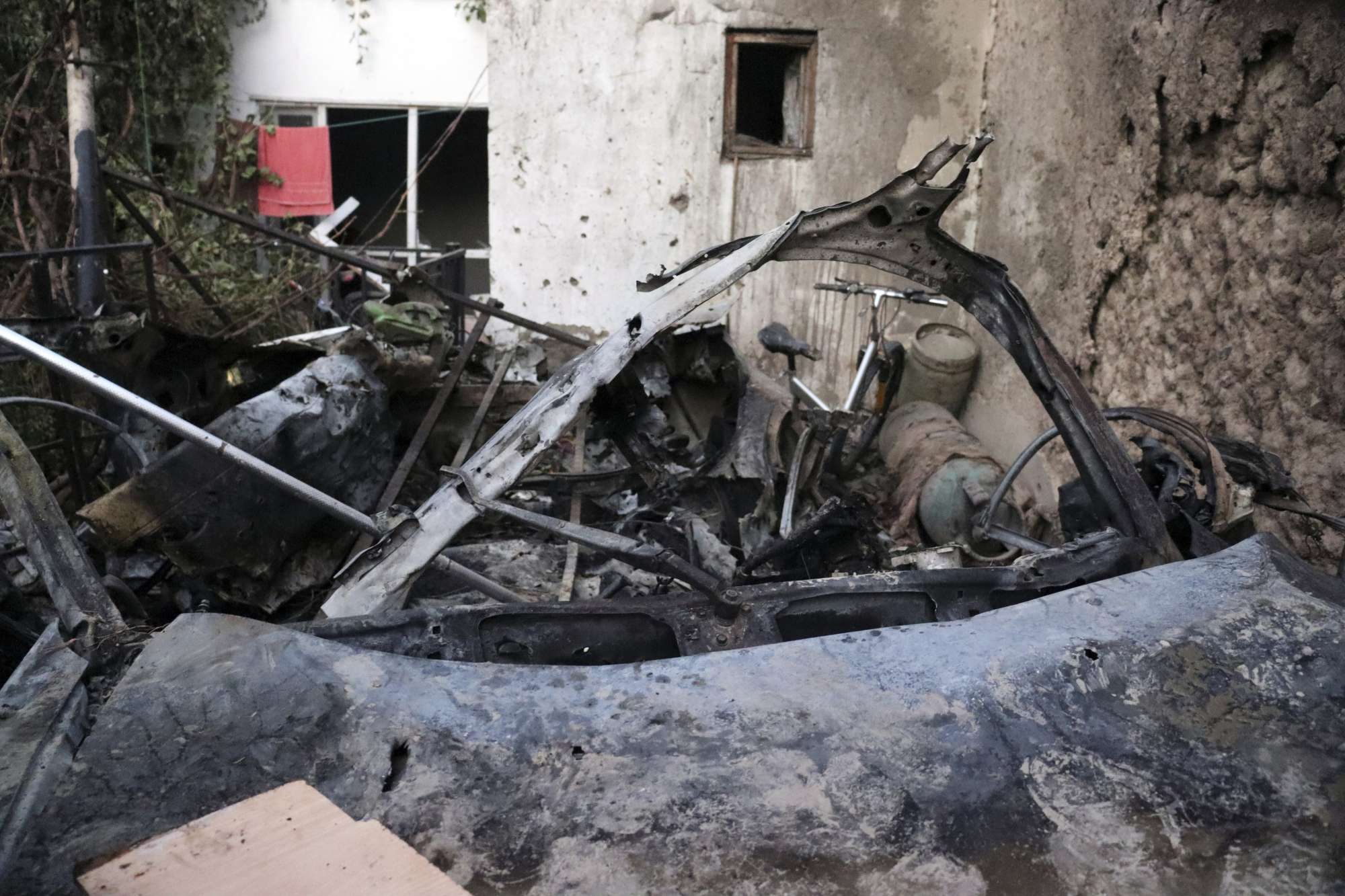 Destroyed vehicle is seen inside a house after U.S. drone strike in Kabul, Afghanistan, Sunday, Aug. 29, 2021. A U.S. drone strike destroyed a vehicle carrying "multiple suicide bombers" from Afghanistan's Islamic State affiliate on Sunday before they could attack the ongoing military evacuation at Kabul's international airport, American officials said. (AP Photo/Khwaja Tawfiq Sediqi)