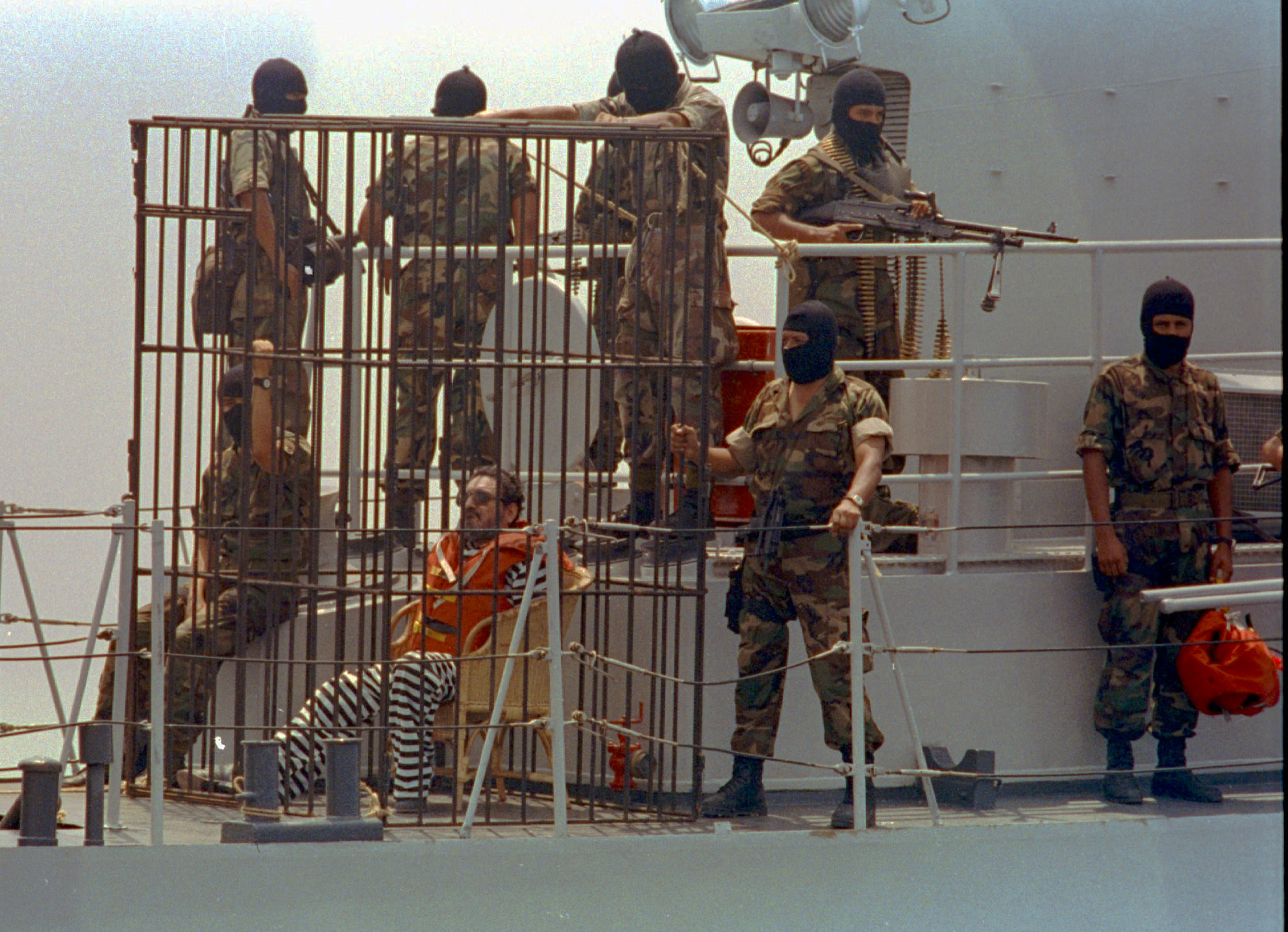 Shining Path leader Abimael Guzman is seen being transfered in this April 3, 1993 photo, from confinement on a rocky island to a new maximum security prison in a Navy Base in Callao, Peru. Transfer was made an a Navy ship where Guzman was caged and under heavy security. The Shining Path was founded in 1970 by Guzman and took up arms a decade later, intent on imposing a regime along the ideals of China's Mao Tse-tung. Guzman instilled an almost religious zeal in his followers and convinced them that Sendero Luminoso, as the group is called in Spanish, would one day rule Peru and then carry the revolution even into the heart of hated capitalism: the United States.(AP Photo/Vera Lentz)