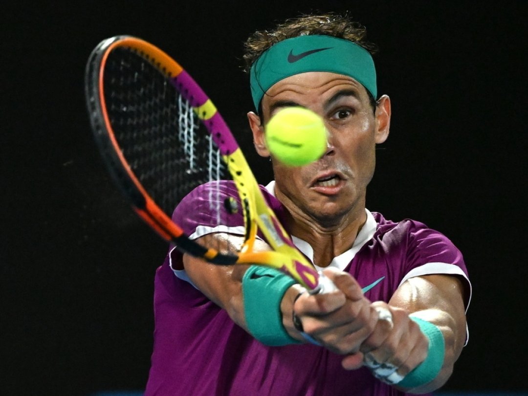epa09717854 Rafael Nadal of Spain plays a shot during the men?s singles final against Daniil Medveded of Russia at the Australian Open grand slam tennis tournament at Melbourne Park in Melbourne, Australia, 30 January 2022. EPA/DEAN LEWINS AUSTRALIA AND NEW ZEALAND OUT