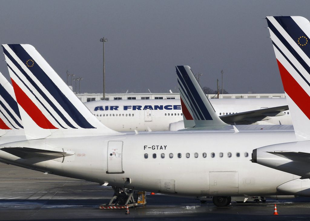 FILE - In this Feb. 7, 2012 file photo, Air France planes are parked on the tarmac at Paris Charles de Gaulle airport, in Roissy, near Paris. Air France says Thursday June 21, 2012 it is aiming to reduce staff numbers by more than 10 percent, after a sustained slide in income. The airline is presenting a plan to its works council that would cut 5,122 employees through a process of voluntary redundancies and not filling vacant positions. (AP Photo/Christophe Ena, File)