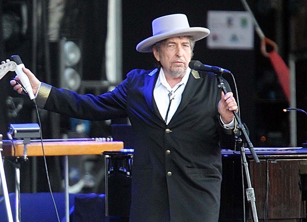 FILE - This July 22, 2012 file photo shows U.S. singer-songwriter Bob Dylan performing on at "Les Vieilles Charrues" Festival in Carhaix, western France. St. Martin?s Press announced Tuesday that it had acquired ?Another Side of Bob Dylan,? by Dylan's tour manager Victor Maymudes who died in 2001. The book is being written by Maymudes? son, Jacob, and will be based on memories the elder Maymudes tape recorded shortly before his death.  (AP Photo/David Vincent, File)