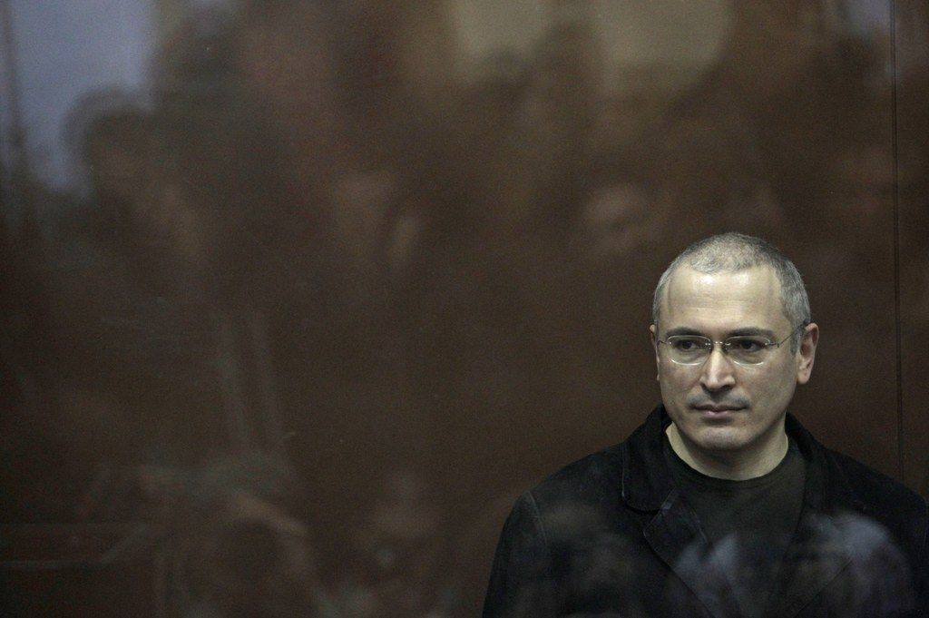 FILE - In this Monday, Dec. 27, 2010 file photo former oil tycoon Mikhail Khodorkovsky stands behind glass at a court room in Moscow, Russia. President Vladimir Putin said on Thursday, Dec. 19, 2013, that he will pardon jailed oil tycoon Mikhail Khodorkovsky after more than a decade in prison. Putin told reporters after his marathon news conference that Khodorkovsky submitted an appeal for pardon and he intends to grant it. (AP Photo/Sergey Ponomarev)