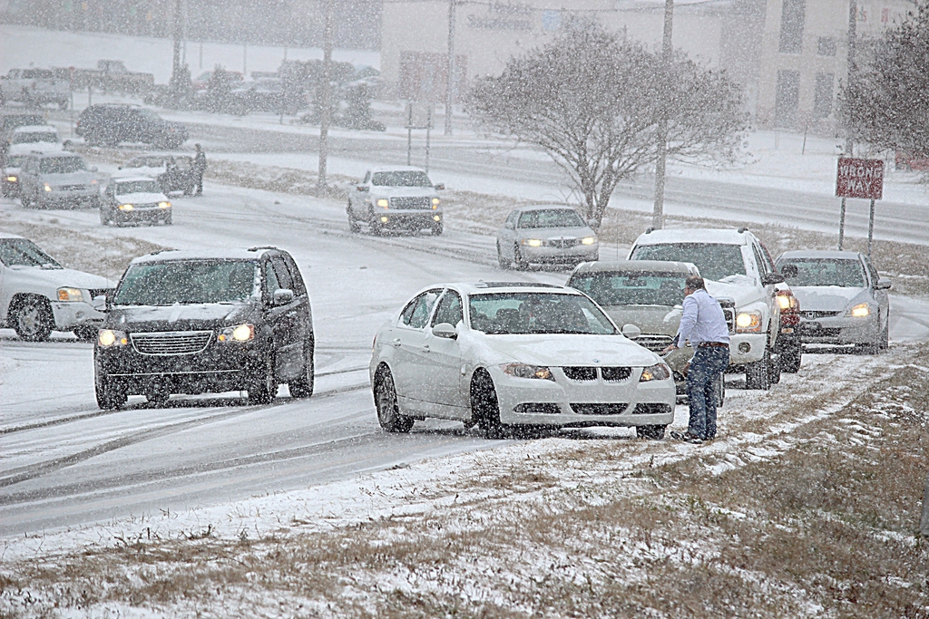 Several cars slid off the road on Highway 39 North leading out of Meridian, Miss., Tuesday Jan. 28, 2014. Several of the vehicles were locked and abandoned to be picked up when the weather conditions improved. (AP Photo/The Meridian Star, Brian Livingston)