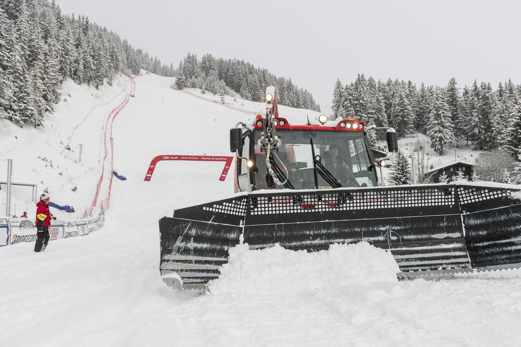 A snow vehicule moves snow from the finish area of the slope Mont-Lachaux ahead of the women's Downhill race of the FIS Alpine Ski World Cup season in Crans-Montana, Switzerland, Friday, February 28, 2014. The second training run was cancelled due to abundant snowfall. (KEYSTONE/Alessandro della Valle)
