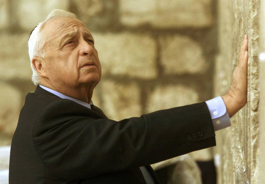 Ariel Sharon, then Israel's Prime Minister-elect, looks up as his touches Judaism holiest site, the Western Wall, in Jerusalem, Wednesday, Feb. 7, 2001.Sharon underwent an additional brain scan Saturday, as doctors prepared to assess how much damage the Israeli leader has suffered from his severe stroke. (KEYSTONE/AP Photo/David Guttenfelder)