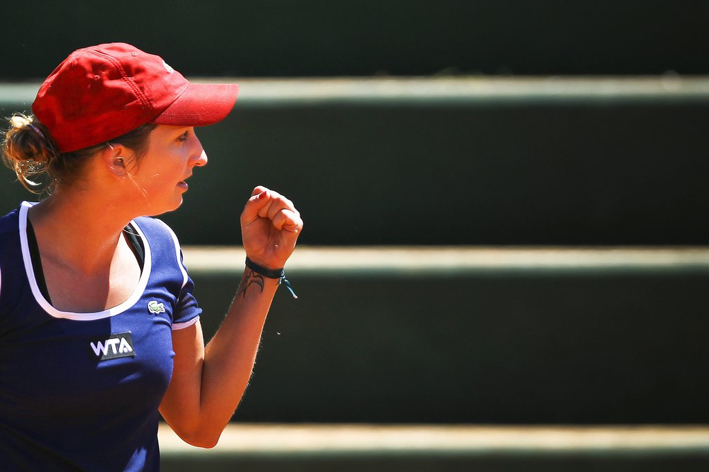 epa04186421 Timea Bacsinszky of Switzerland celebrates after winning a point against Ons Jabeur of Tunisia during their second round match of the Portugal Open tennis tournament in Estoril, Portugal, 30 April 2014.  EPA/JOSE SENA GOULAO