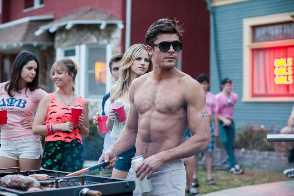 This image released by Universal Pictures shows Zac Efron in a scene from the film, "Neighbors." In the upcoming months, charming indies and raunchy comedies, starting with Friday, May 9, 2014 release of "Neighbors," will appeal to those looking for films that reflect their own lives. (AP Photo/Universal Pictures, Glen Wilson)