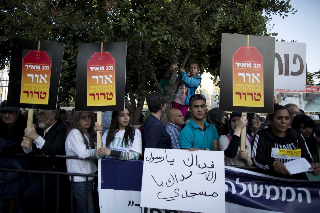 Des manifestants de toutes les communautés religieuses tenant des pancartes 'Lumière au lieu de terreur' devant la résidence de Benjamin Netanyahu, à Jérusalem.