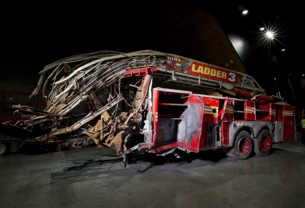 epa04205493 A handout image released on 14 May 2014 by the 9/11 Memorial Museum shows a FDNY Ladder Company 3 from which all 11 responding members of Ladder Company 3 were killed inside the North Tower when it collapsed at 10:28 a.m. The front cab of this fire truck was shorn off when the North Tower collapsed, inside the 9/11 Memorial Museum at the World Trade Center site in New York City, New York, USA, 14 May 2014.  The Museum's official dedication ceremony will be held 15 May 2014 and will open to the public on 20 May 20  EPA/JIN LEE / 9/11 MEMORIAL MUSEUM / HANDOUT  HANDOUT EDITORIAL USE ONLY/NO SALES
