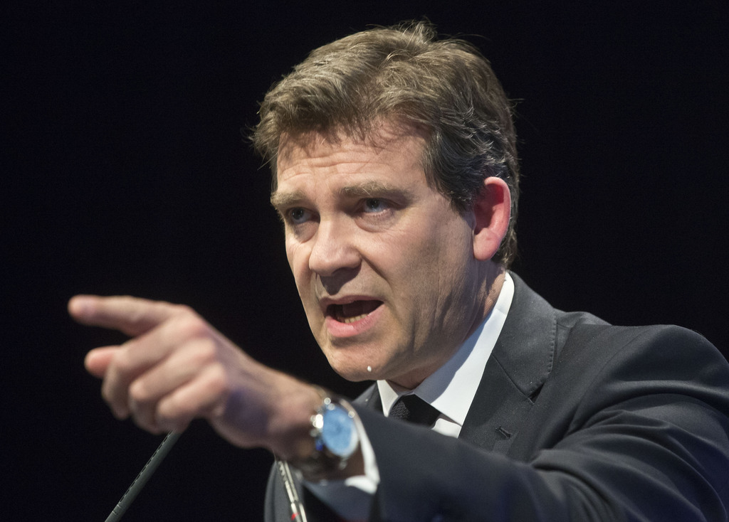 Economy Minister Arnaud Montebourg, gestures as he speaks during a panel of the Open Internet Project in Paris, Thursday, May 15, 2014.  The French government is broadening its authority to intervene when foreign companies want to buy firms the state considers vital, including in the sectors of transport, health and communications. The order released Thursday goes into effect immediately, potentially giving the Socialist government more leverage amid General Electric's $17 billion for the energy division of the French conglomerate Alstom, which makes power plant turbines and pioneered high-speed TGV trains. (AP Photo/Michel Euler)