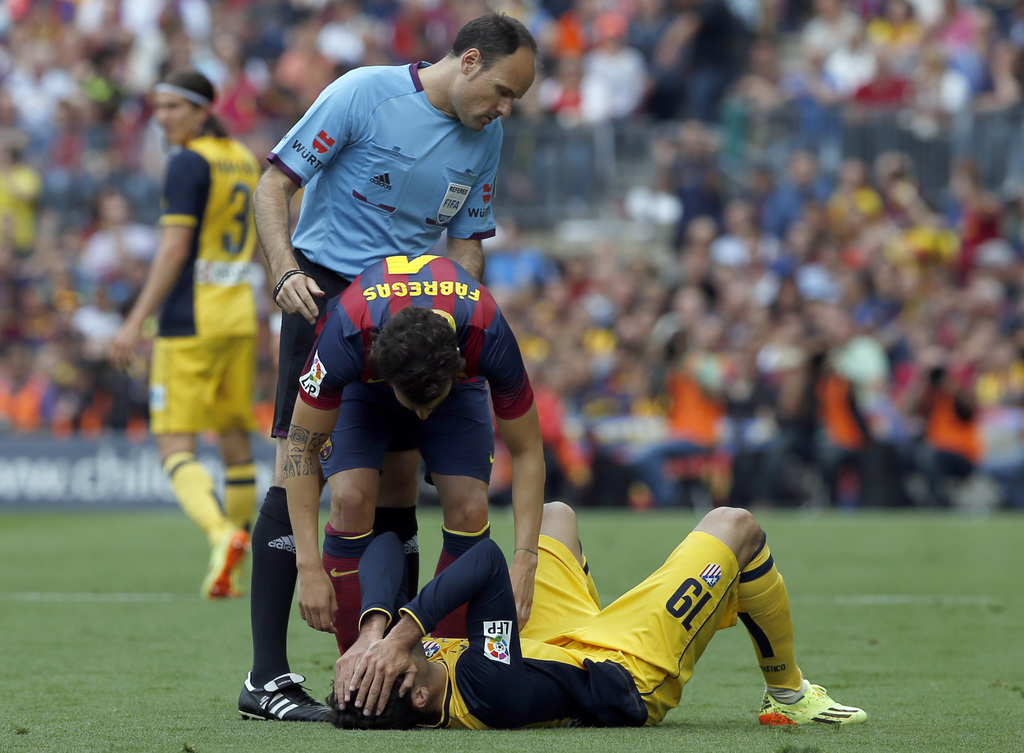Atletico's Diego Costa lies injured on the pitch during a Spanish La Liga soccer match between FC Barcelona and Atletico Madrid at the Camp Nou stadium in Barcelona, Spain, Saturday, May 17, 2014. (AP Photo/Emilio Morenatti)