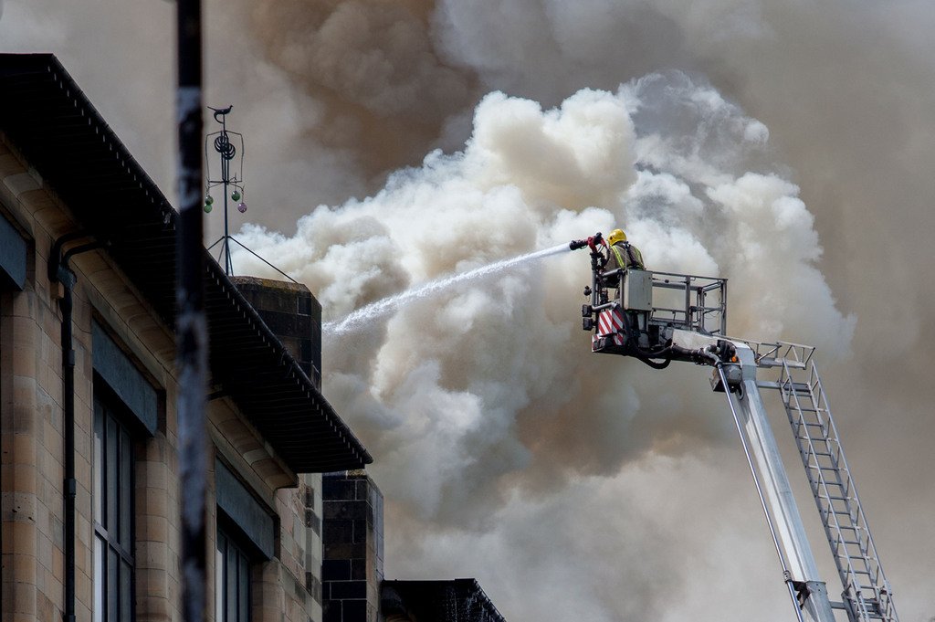 In this photo released by David Barz , firefighters attend a fire at  Glasgow School of Art, Glasgow, Scotland, Friday, May 23, 2014.    A major fire has devastated the Glasgow School of Art, one of the city's major landmarks. The Scottish Fire and Rescue Service said the blaze, which broke out just after noon on Friday, was a "very significant fire." Flames flared through the roof and windows of the sandstone Art Nouveau building, designed by architect Charles Rennie Mackintosh and completed in 1909. A 2009 poll by the Royal Institute of British Architects voted it the best British building of the last 175 years. (AP Photo / David Barz)