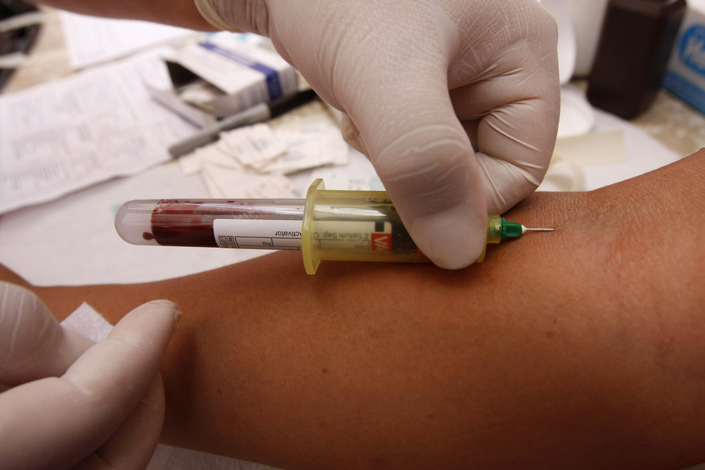 A health worker takes a blood sample for an HIV test in San Salvador, Friday, June 25, 2010. El Salvador's health officials held Friday a national campaign on HIV testing. (AP Photo/Luis Romero)