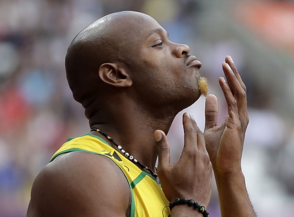 In this Aug. 4, 2012 file photo, Jamaica's Asafa Powell prepares to compete in a men's 100-meter heat at the 2012 Summer Olympics in London. Powell has been banned from his sport for 18 months. The 31-year-old sprinter tested positive for the banned stimulant oxilofrone at Jamaica's national trials last June. (AP Photo/Matt Slocum, File)