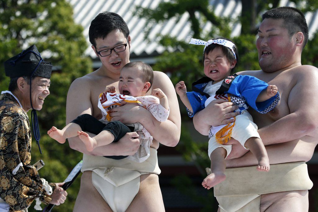 Babies, held by amateur sumo wrestlers, compete for the loudest crying during the Nakizumo, or crying baby contest, at Sensoji Temple in Tokyo, Japan, 26 April 2014. Babies, accompanied by amateur wrestlers, are held face to face to determine how loud and long they can cry in the traditional crying contest to celebrate their growth and pray for their good health. Some 120 babies attended the event this year.  EPA/KIYOSHI OTA