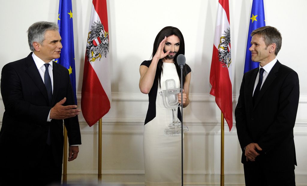 Austrian Federal Chancellor Werner Faymann, left, and Federal Minister for Arts and Culture Josef Ostermayer, right, welcome Austrian singer and Eurovision Song Contest winner Conchita Wurst at the federal chancellery in Vienna, Austria on Sunday, May 18, 2014.   The bearded drag queen Conchita Wurst had made a triumphant return to Austria last week  after winning the Eurovision Song Contest in Copenhagen  in what the country's president called a victory for tolerance in Europe. (AP Photo/Hans Punz)