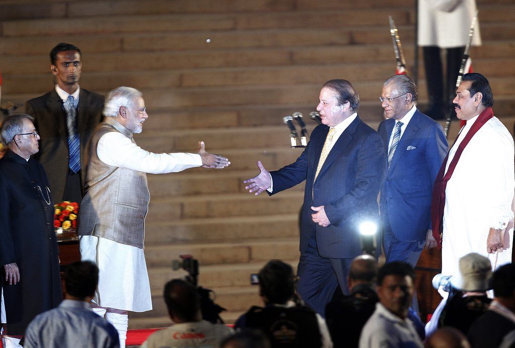 Indian Prime Minster Narendra Modi (2-L) shake hands with Pakistani Prime Minister Nawaz Sharif after talking the oath as India's new Prime Minister as Indian President Pranab Mukherjee (L) and Sri Lanka President Mahinda Rajapakse (R) look on during the swearing-in ceremony at the presidential palace in New Delhi, India on 26 May 2014. Narendra Modi was sworn in as India's 15th prime minister on and vowed to build a 'glorious future' for the South Asian country. Modi, 63, took the oath before an estimated 4,000 guests, including his counterpart from rival Pakistan Nawaz Sharif on the forecourt of the presidential palace in New Delhi.  EPA/HARISH TYAGI