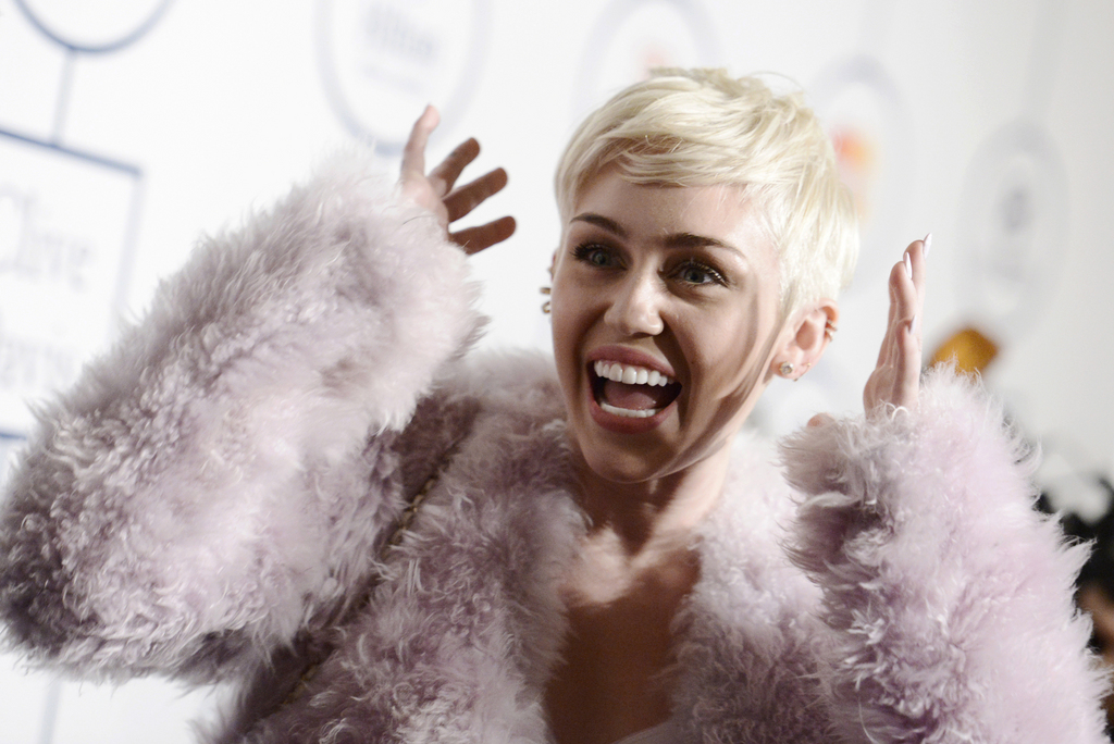 FILE - In this Jan. 25, 2014 file photo, Miley Cyrus arrives at the 56th annual GRAMMY awards - salute to industry icons with Clive Davis, in Beverly Hills, Calif. Cyrus is in the hospital and unable to perform her ?Bangerz? concert at Kansas City?s Sprint Center as planned. A Cyrus spokeswoman says the 21-year-old entertainer canceled her performance Tuesday, April 15, 2014, after she was hospitalized for a severe allergic reaction to antibiotics. (Photo by Dan Steinberg/Invision/AP, file)