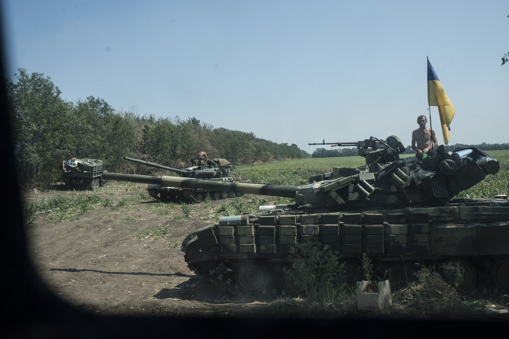 In this photo taken on Thursday, Aug.  14, 2014, Ukrainian army tanks take their positions near Illovaisk, Donetsk region, eastern Ukraine. Ukrainian forces have stepped up efforts to dislodge the separatists from their last strongholds in Donetsk and Luhansk and there was more heavy shelling overnight. (AP Photo/Evgeniy Maloletka)