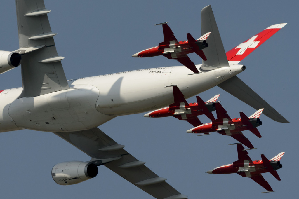 Escorted by six Tiger F5-E jets of the Patrouille Suisse an Swiss Air Lines Airbus A330 flys over the spectators at the AIR14 air show in Payerne, Switzerland, Saturday, September 6, 2014. The Air show AIR14 of the Swiss army marks the 100th anniversary of the Air Force also as the 50th anniversary of the Patrouille Suisse and the 25th anniversary of the PC-7 Team. AIR 14 runns during two different weekends, the 30 and 31 August and the 6 and 7 September 2014. (KEYSTONE/Laurent Gillieron)