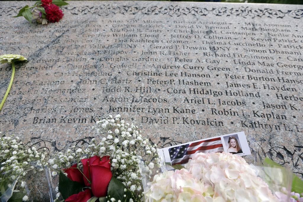 A card honoring attack victim Jennifer Kane sits at the 9/11 Memorial in the Public Gardens during a ceremony in Boston commemorating the anniversary of the terrorist attacks Thursday, Sept. 11, 2014. The two planes hijacked by the terrorists and crashed in the the World Trade Center towers in New York 13 years ago departed from Logan International Airport in Boston. (AP Photo/Steven Senne)