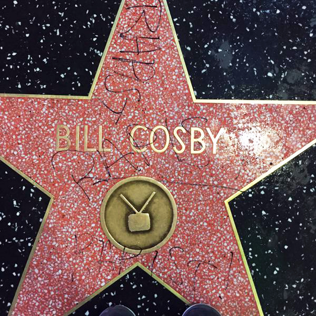 This Dec. 2, 2014 photo by Josh Keown posted on his Twitter page shows the graffiti scrawled on the Hollywood Walk of Fame star of actor-comedian Bill Cosby in the Hollywood district of Los Angeles. The word "rapist" was scrawled on the star three times. Cosby has been accused by more than a dozen women of drugging them and sexual abuse, but he has never been charged with a crime. The star was scrubbed clean Friday, Dec. 5, 2014. Cosby received his star in 1977, near the busy intersection of Hollywood Boulevard and North Highland Avenue. (AP Photo/Josh Keown)