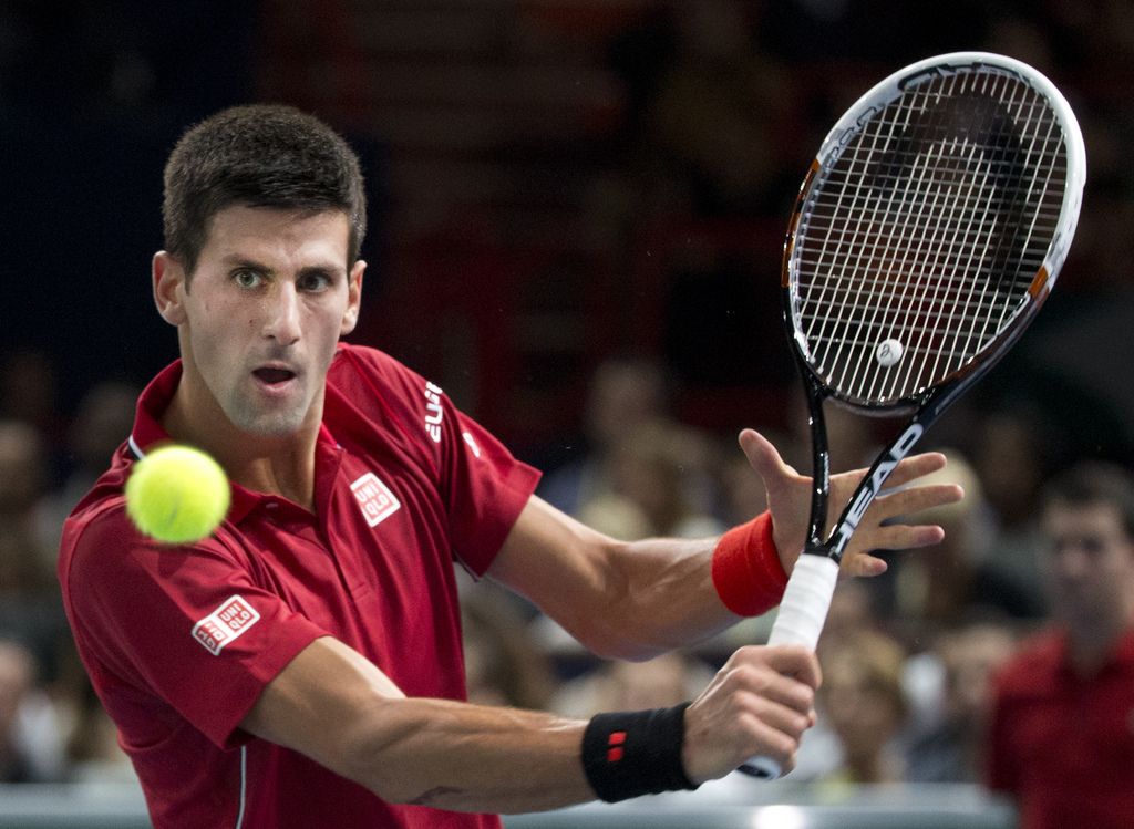 Serbia's Novak Djokovic returns the ball to Gael Monfils of France after their third round match at the ATP World Tour Masters tennis tournament at Bercy stadium in Paris, France,  Thursday, Oct. 30, 2014. (AP Photo/Jacques Brinon)