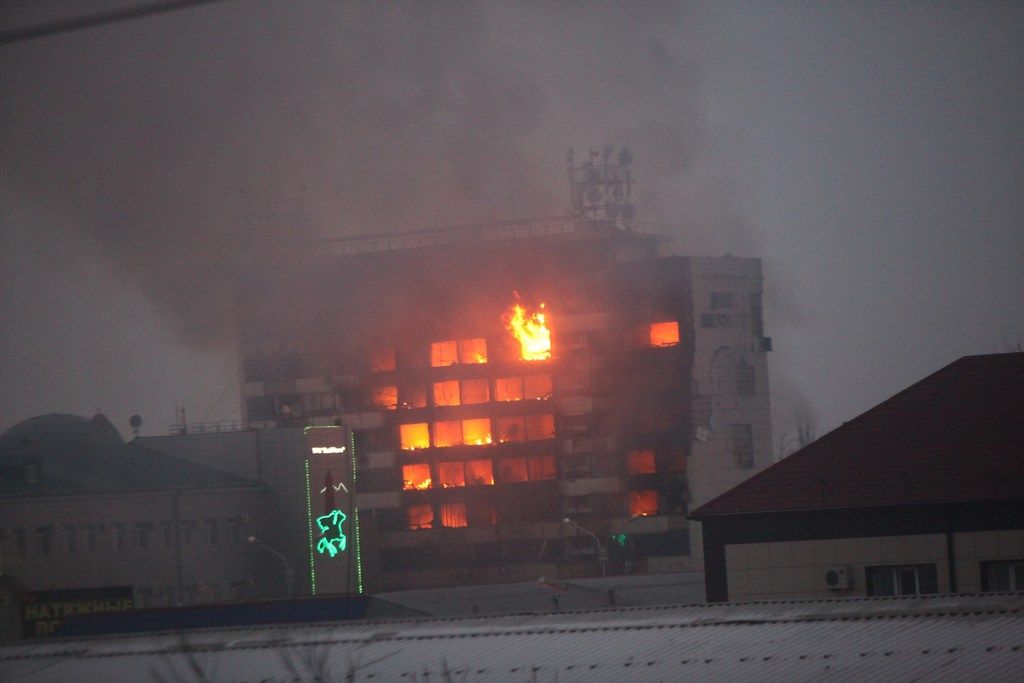 A publishing house building is seen in flames in the center of Grozny, Russia, early Thursday, Dec. 4, 2014. A gun battle broke out after midnight Thursday in the capital of Russia?s North Caucasus republic of Chechnya, puncturing the patina of stability ensured by years of heavy-handed rule by a Kremlin-appointed leader. Security officials and the leader of Chechnya said gunmen traveling in several cars killed at least three traffic police officers at a checkpoint late at night in the capital of the republic, Grozny. The Moscow-based National Anti-Terrorist Committee said in a statement that after the attack on the traffic police, gunmen occupied the publishing house. It said security services, police and emergency services personnel surrounded the building. (AP Photo/Musa Sadulayev)