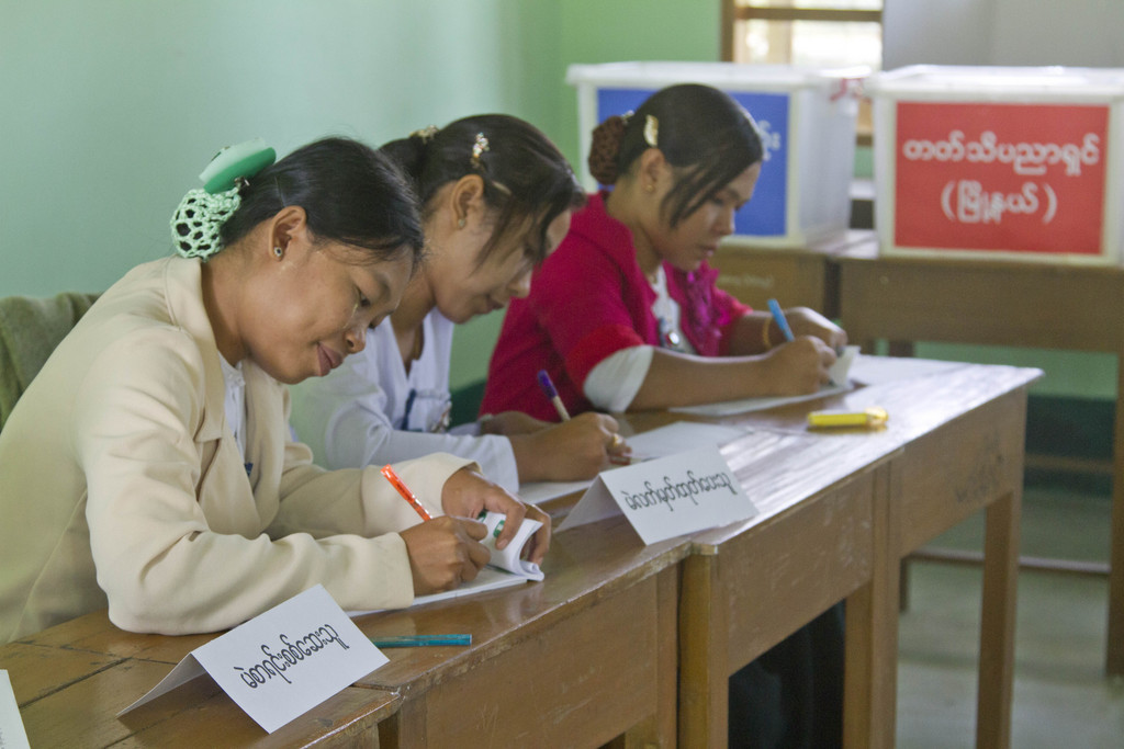 Myanmar civil servants register voters  during a municipal election at a polling station in Dala township, Saturday, Dec.27, 2014, in Yangon, Myanmar. The historic Yangon City municipal election is held for the first time in almost six decades in Yangon. Nearly 300 candidates contest for 115 seats of different levels of municipal committees that were appointed position in the past under military regime. The election does not include the post for mayoral position. (AP Photo/Khin Maung Win)