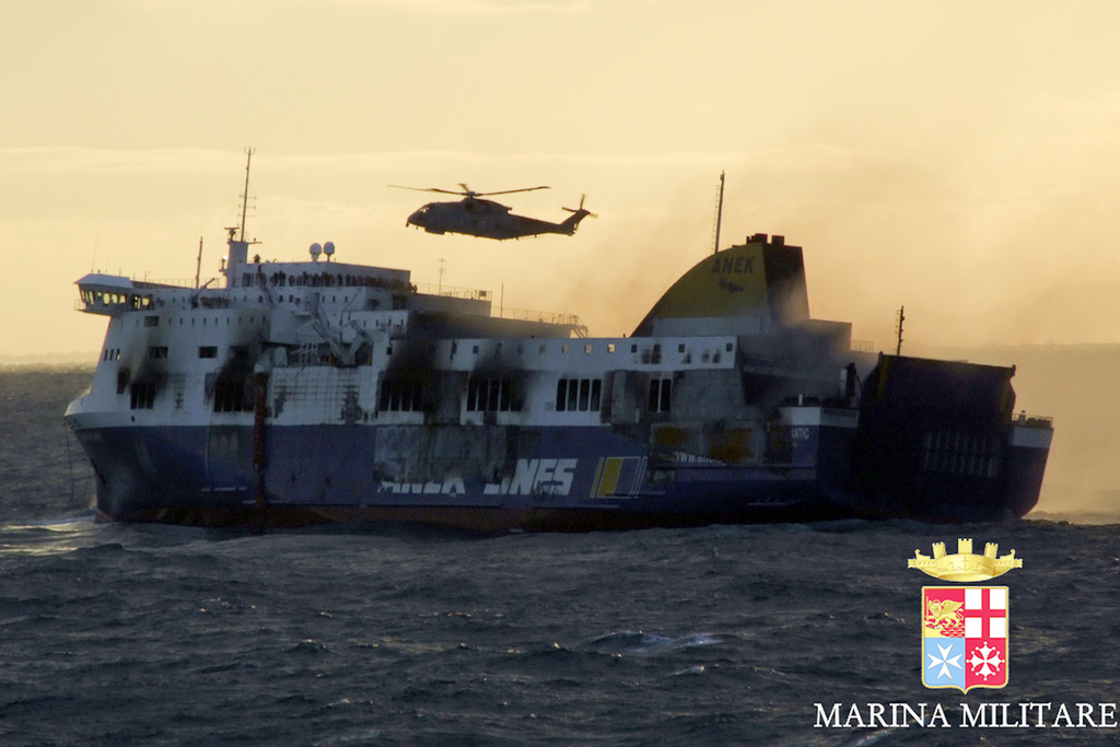 In this image released by the Italian Navy, smoke billows from the Italian-flagged Norman Atlantic that caught fire in the Adriatic Sea, Monday, Dec. 29, 2014. A cargo ship with 49 people evacuated from a Greek ferry that caught fire in the Adriatic Sea arrived in the Italian port of Bari on Monday, the first big group to reach land. More than 160 people remained trapped on the smoke-filled vessel adrift in frigid temperatures and rough seas between Italy and Albania. One person was killed in the risky rescue operation and two others were injured as Italian and Greek rescue ships and helicopters worked through the night plucking passengers off the stricken vessel and bringing them to safety aboard the 10 or so mercantile ships nearby that were summoned to help. (AP Photo/Italian Navy, ho)