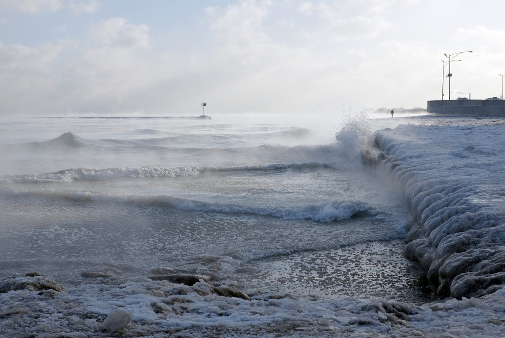 Ice forms as waves crash along Lake Michigan in below-normal temperatures near Oak Street Beach, Monday, Jan. 5, 2015, in Chicago. Forecasters expect significant snowfall and freezing temperatures this week in northern Illinois. (AP Photo/Kiichiro Sato)