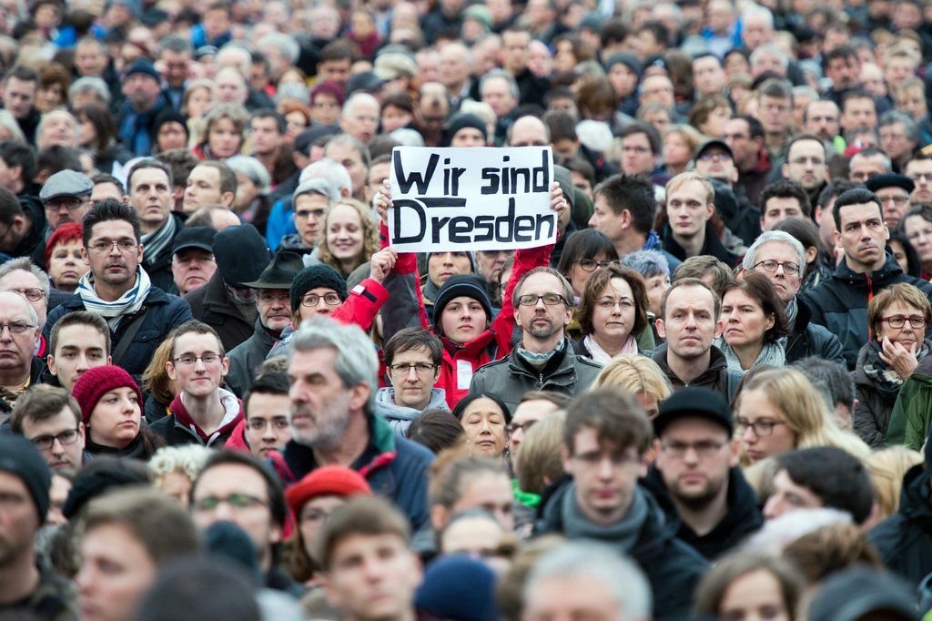 epa04553933 Thousands of people participate in a rally under the motto 'For Dresden, for Saxony - for cultural openness, humanity and dialogue in cooperation' in front of the Frauenkirche (Church of Our Lady) in Dresden, Germany, 10 January 2015. One poster reads 'We are Dresden'. The Lord Mayor of Dresden, Helma Orosz, and the Minister President of Saxony, Stanislaw Tillich, had called for the rally. An anti-Islam movement called 'Pegida' has staged weekly protests in the eastern German city of Dresden since October.  EPA/ARNO BURGI