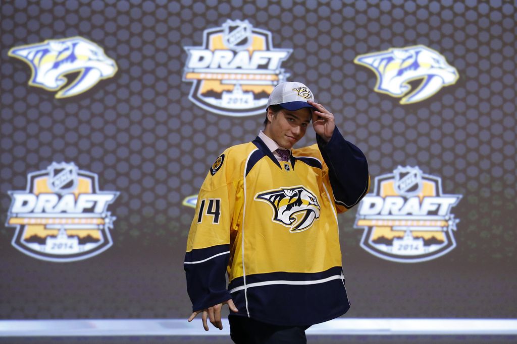 Kevin Fiala walks off the stage after being chosen 11th overall by the Nashville Predators during the first round of the NHL hockey draft, Friday, June 27, 2014, in Philadelphia. (AP Photo/Matt Slocum)