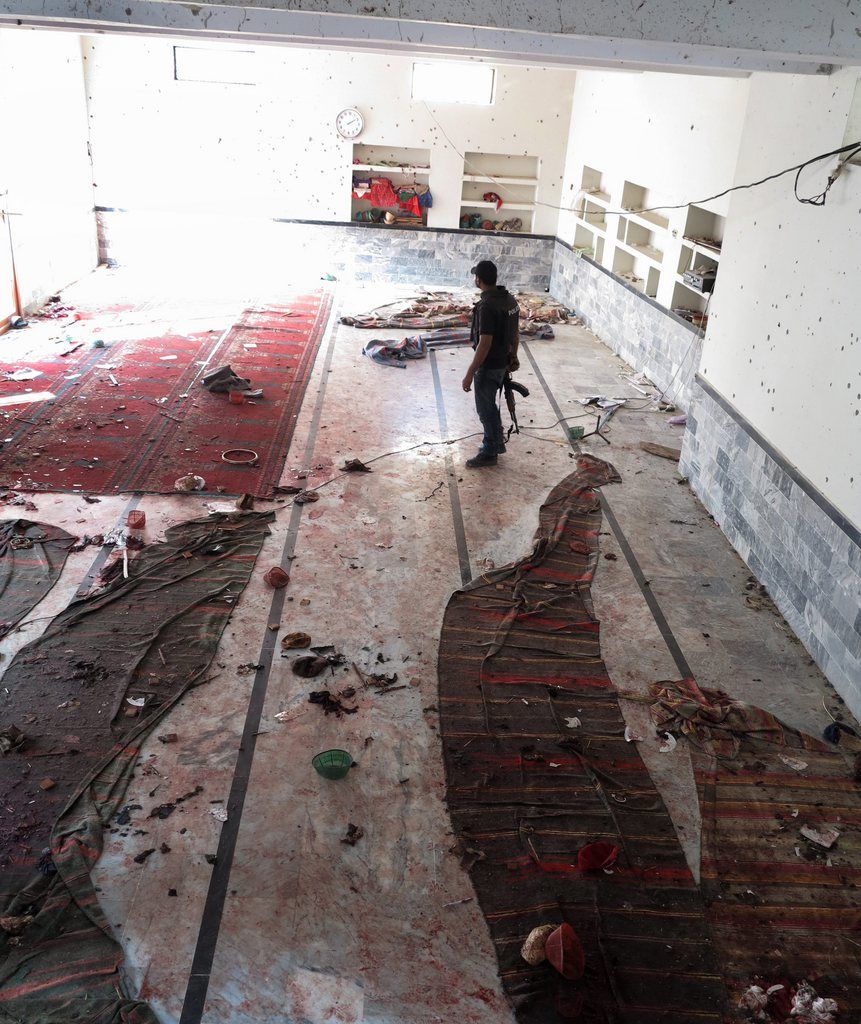 epa04594767 A Pakistani security official inspects the scene of a suicide bomb blast targeting a Shi'ite Muslims Mosque in the Lakhi Dar area of Shikarpur, Pakistan, 30 January 2015. At least 43 worshippers were killed and more than 40 injured on 30 January in bombing at a Shiite mosque in Pakistan's southern province of Sindh, officials said. The bombing occurred in the Lakhi Dar area of Shikarpur during Friday prayers. City police chief Saqib Ismail Memon confirmed the bombing.  EPA/WAQAR HUSSEIN