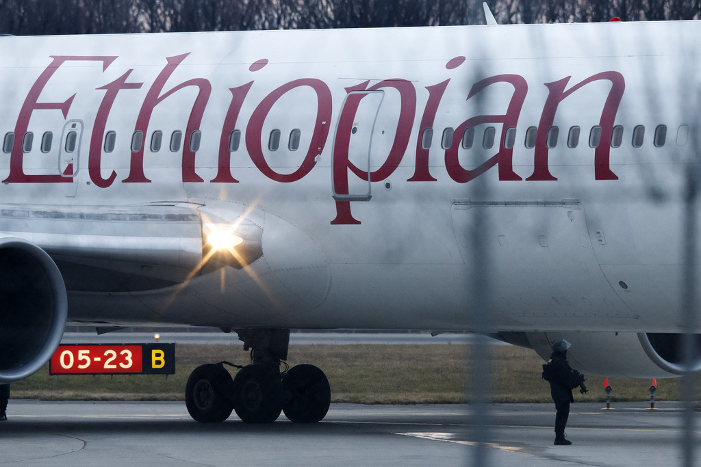 A security force stands next to a hijacked Ethiopian Airlines Plane on the airport in Geneva, Switzerland, Monday, February 17, 2014. A hijacked aircraft travelling from Addis Abeda, Ethiopia, to Rome, Italy, has landed at Geneva's international airport early Monday morning. Swiss authorities have arrested the hijacker, all 200 passengesr are in good health. (KEYSTONE/Salvatore Di Nolfi)