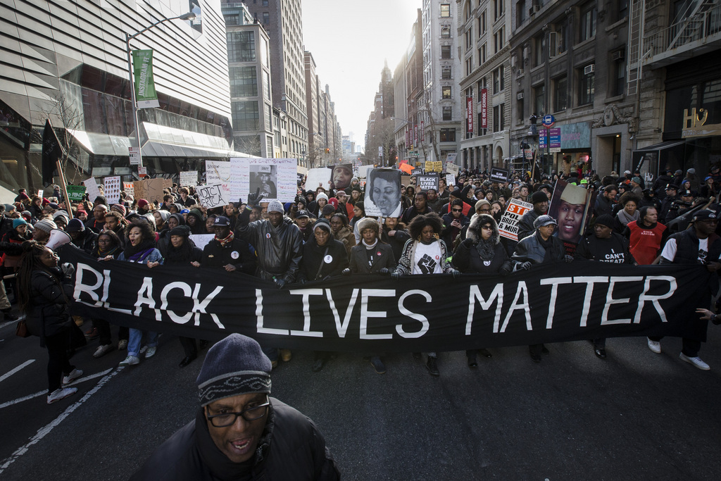 Demonstrators march in New York, Saturday, Dec. 13, 2014, during the Justice for All rally and march. In the past three weeks, grand juries have decided not to indict officers in the chokehold death of Eric Garner in New York and the fatal shooting of Michael Brown in Ferguson, Mo. The decisions have unleashed demonstrations and questions about police conduct and whether local prosecutors are the best choice for investigating police. (AP Photo/John Minchillo)