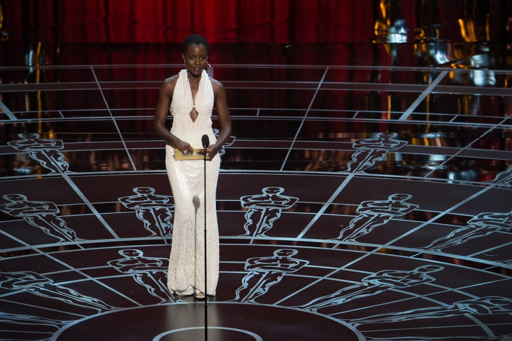 epa04633381 A handout picture provided by the Academy of Motion Picture Arts and Science (AMPAS) on 23 February 2015 shows Lupita Nyong'o presenting during the 87th annual Academy Awards ceremony at the Dolby Theatre in Hollywood, California, USA, 22 February 2015. The Oscars are presented for outstanding individual or collective efforts in up to 24 categories in filmmaking.  EPA/MARK SUBAN / AMPAS THE IMAGE MAY NOT BE ALTERED. THE IMAGE IS FREE FOR EDITORIAL USE IN REPORTING ABOUT THE EVENT. HANDOUT EDITORIAL USE ONLY/NO SALES/NO ARCHIVES