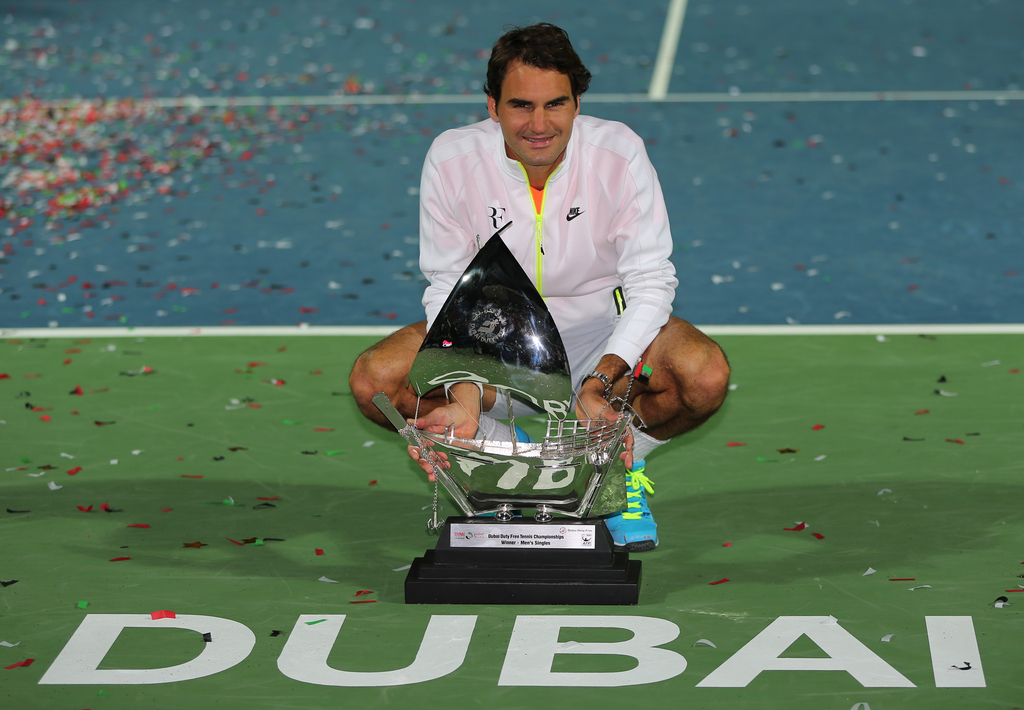 Roger Federer of Switzerland holds the trophy after defeating Novak Djokovic of Serbia in the final match of the Dubai Duty Free Tennis Championships in Dubai, United Arab Emirates, Saturday, Feb. 28, 2015. (AP Photo/Kamran Jebreili)