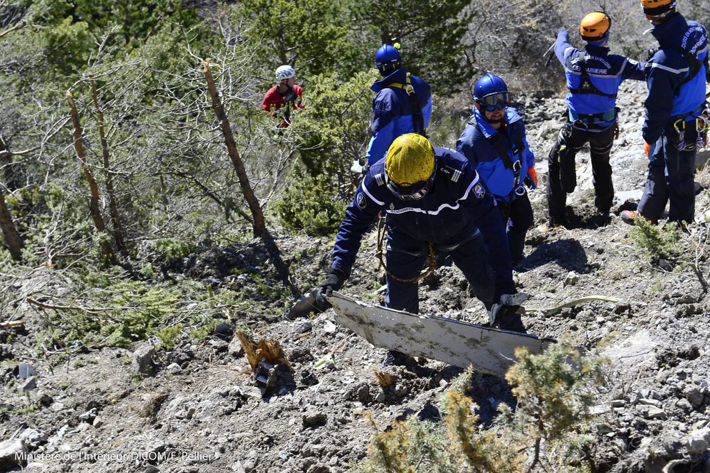 epa04681292 A handout photo provided by the French Interior Ministry on 27 March 2015 shows search and rescue workers making their way through debris at the crash site of the Germanwings Airbus A320 in the French Alps, above the town of Seyne-les-Alpes, southeastern France, 26 March 2015. Germanwings Flight 4U 9525, carrying 144 passengers and six crew members from Barcelona, Spain to Dusseldorf, Germany, crashed 24 March in the French Alps, where searchers combed a 4-hectare section of mountain face since 25 March. The co-pilot deliberately crashed the aircraft, French officials said on 26 March.  EPA/FRANCIS PELLIER/DICOM/MINISTERE INTERIEUR/HO  HANDOUT EDITORIAL USE ONLY/NO SALES