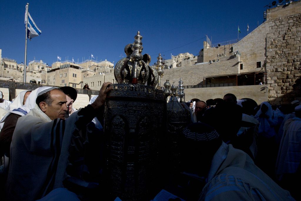 Israelis pray during the Jewish holiday of Passover, in front of the Western Wall, the holiest site where Jews can pray in Jerusalem's old city, Monday, April 6, 2015. The Cohanim, believed to be descendants of priests who served God in the Jewish Temple before it was destroyed, perform a blessing ceremony of the Jewish people three times a year during the festivals of Passover, Shavuot and Sukkot. (AP Photo/Sebastian Scheiner)