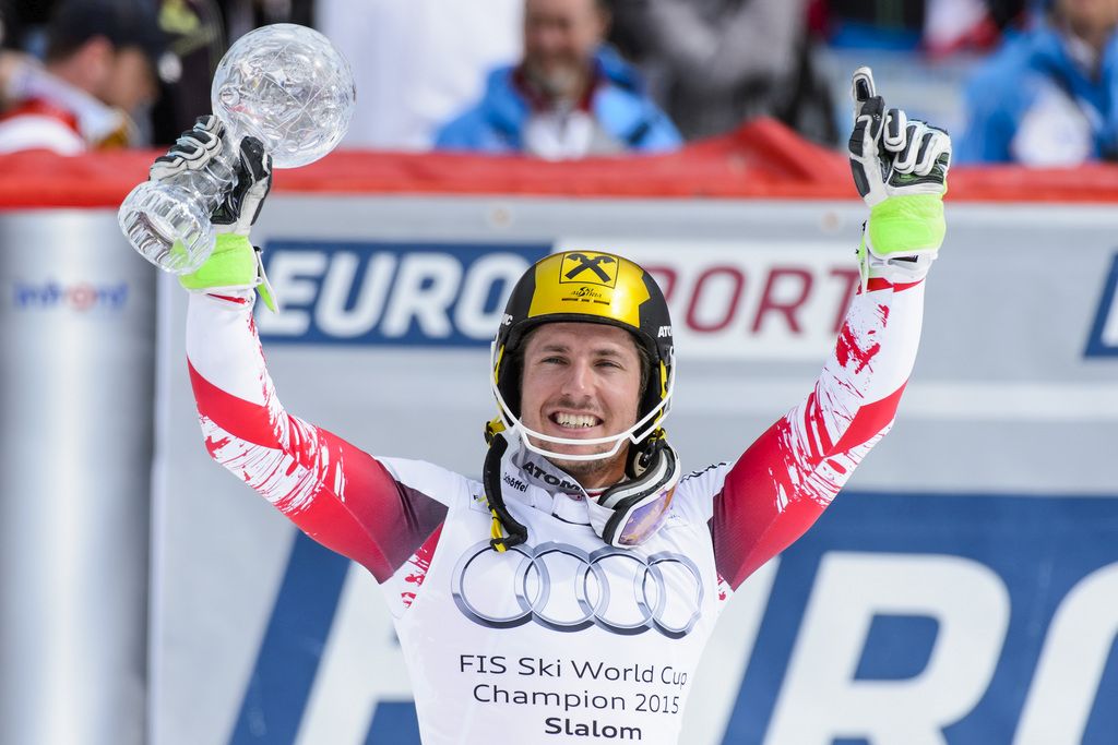 Marcel Hirscher of Austria celebrates with the crystal globe winning the overall men's Slalom competition during the second run of the men's Slalom race of the FIS Alpine Skiing World Cup Finals, in Meribel, France, Sunday, March 22, 2015. (KEYSTONE/Jean-Christophe Bott)