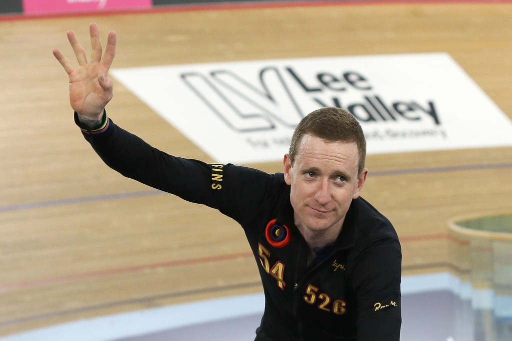 Britain's Sir Bradley Wiggins celebrates breaking the UCI Hour Record at the Olympic Velodrome in Lee Valley Velopark, London, Sunday, June 7, 2015. Former Tour de France winner Bradley Wiggins broke cycling's prestigious hour record, covering 54.526 kilometers (33.88 miles) in 60 minutes. (AP Photo/Tim Ireland)