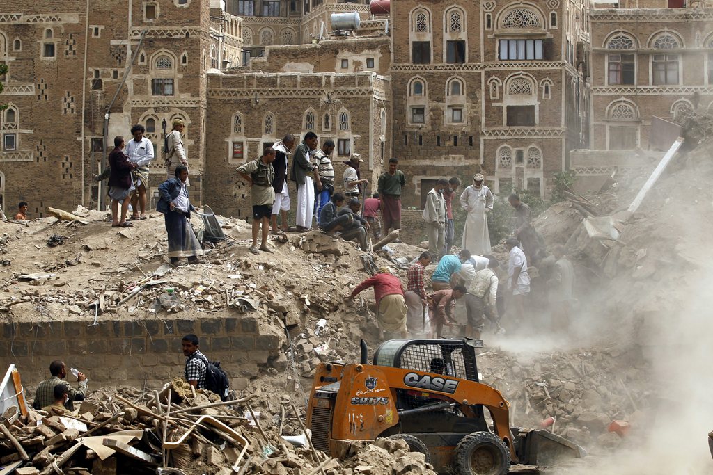 epa04795046 Yemenis search for survivors under the rubble of old buildings allegedly destroyed by an airstrike carried out by the Saudi-led coalition in the old city of Sana?a, Yemen, 12 June 2015. A Saudi-led airstrike killed seven civilians and destroyed historic houses in the old quarter of Sana'a on 12 June, two days ahead of UN-brokered peace talks in Geneva. The air raid was the first in the UNESCO World Heritage Site in Yemen's rebel-held capital since the coalition started its air campaign in March against the Iran-backed Houthi rebels.  EPA/YAHYA ARHAB