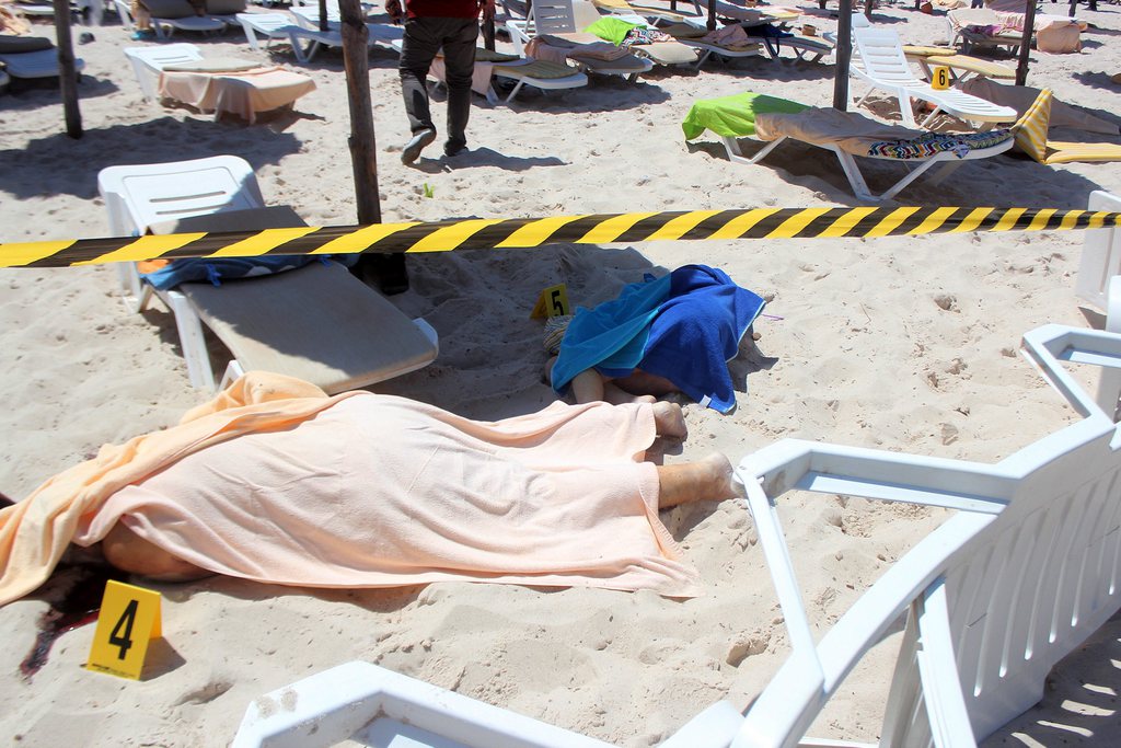 epa04819977 Bodies lie on a beach in al-Sousse, 150 kilometers fromTunisia, 26 June 2015. According to local reports unknown assailants detonated at least one bomb then opened fire on tourists at two hotels, killing at least 27, mostly foreigners, and wounding several others, some while they were sunbathing, at least one of the attackers was killed by Tunisian security services, while a second has been arrested.  EPA/STR