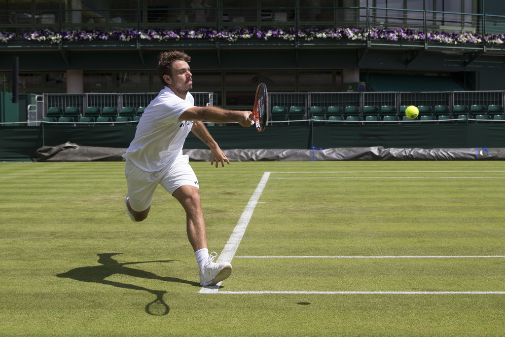 Stanislas Wawrinka, of Switzerland, returns a ball during a training session at the All England Lawn Tennis Championships in Wimbledon, London, Saturday, June 27, 2015. (KEYSTONE/Peter Klaunzer)